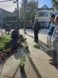 Frankie demonstrates planting techniques during Gardening Workday March 21, 2026